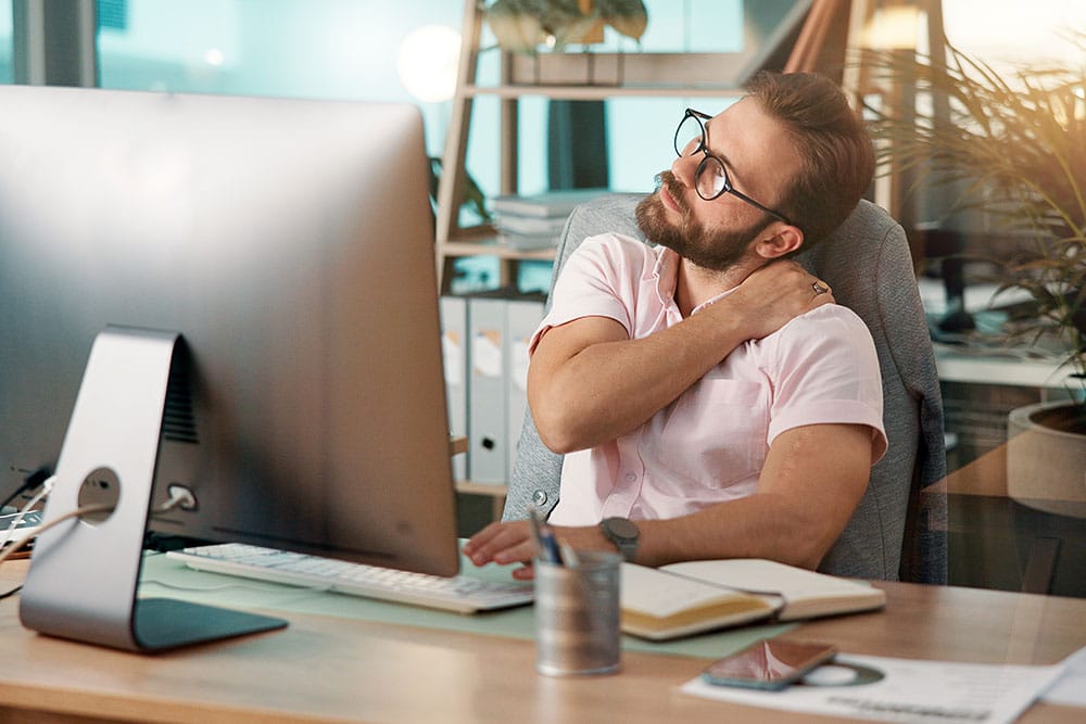 MSK-issues-at-work Person struggling with MSK issues at work