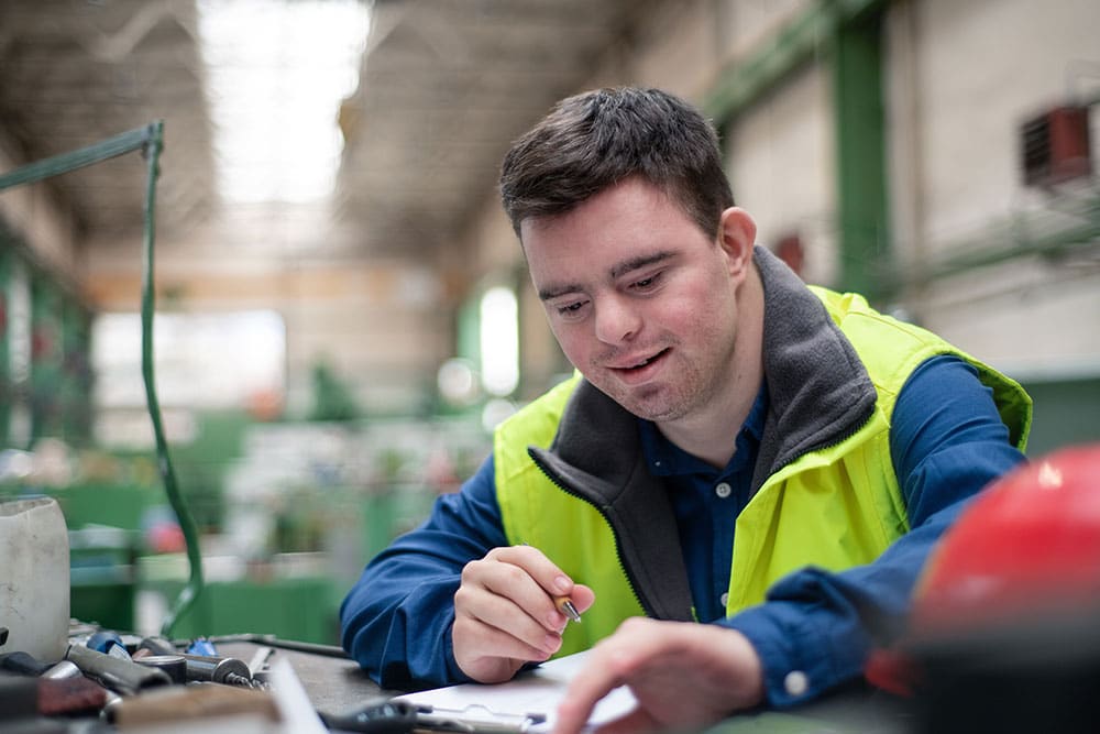 Person-at-work-supported-with-reasonable-adjustments Person supported at work with reasonable adjustments