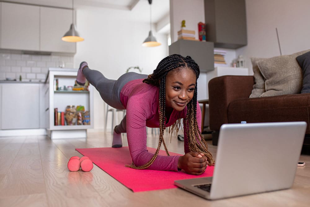 Cost-effective-exercise_09.25 Person using online fitness video to boost wellbeing